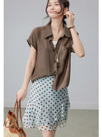Light blue polka dot skirt with tiered ruffles and a feminine silhouette.