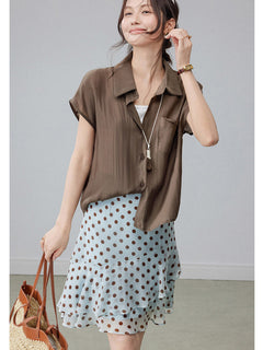 Light blue polka dot skirt with tiered ruffles and a feminine silhouette.