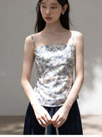 Back view of blue floral smocked camisole with thin straps