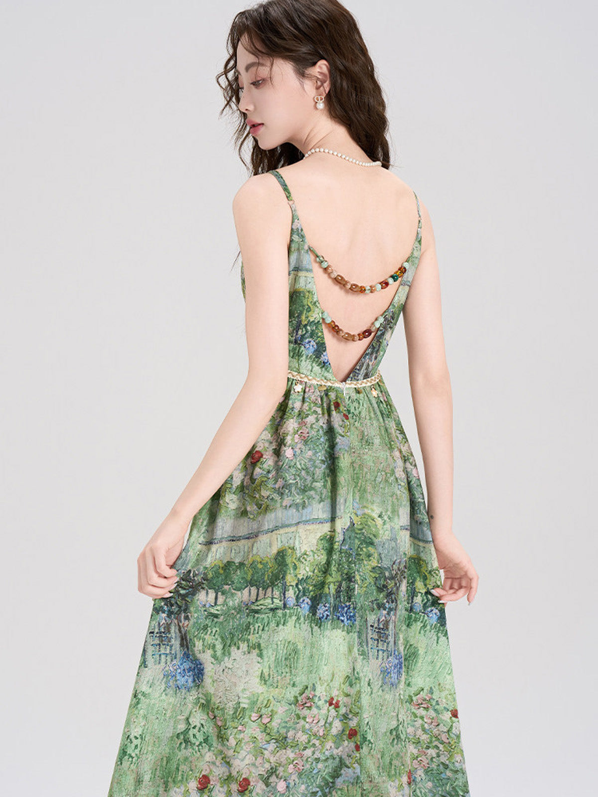 Green floral dress with a v-neckline and thin straps.