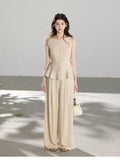 Beige wide-leg pants with pleats at the front of the waist and full-length silhouette