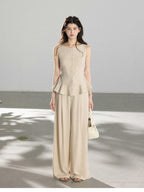Beige wide-leg pants with pleats at the front of the waist and full-length silhouette