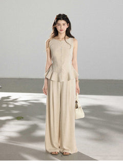 Beige wide-leg pants with pleats at the front of the waist and full-length silhouette