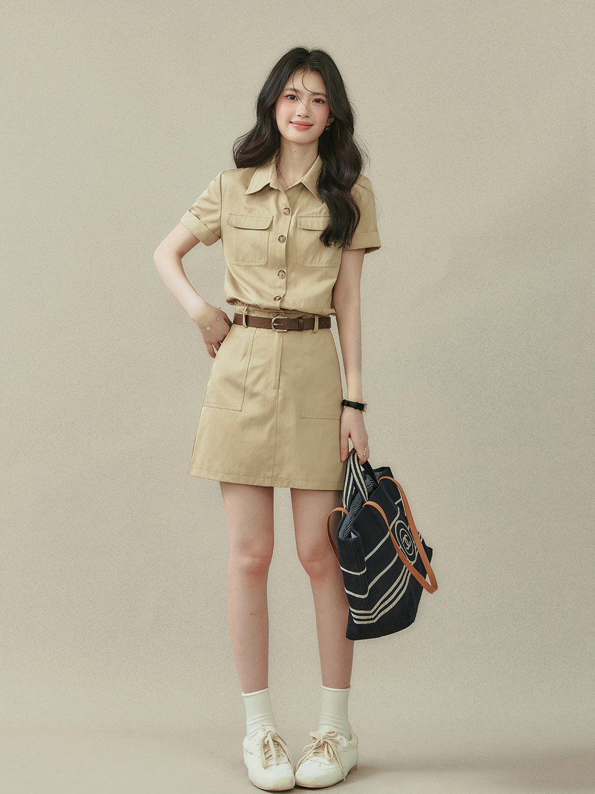 Beige military-style shirt dress with collar and two chest pockets.