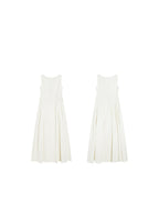 A flat lay of a cream sleeveless A-line floor-length dress with side pleats and a round neckline.