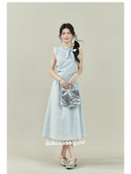 Light blue dress with vertical stripes, lace trim on the shoulders and hem, a bow tie neckline, gathered waist, and A-line silhouette.