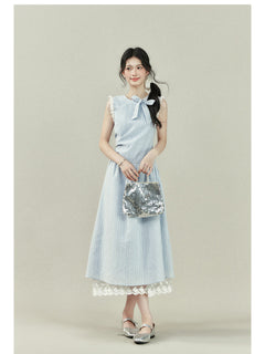 Light blue dress with vertical stripes, lace trim on the shoulders and hem, a bow tie neckline, gathered waist, and A-line silhouette.