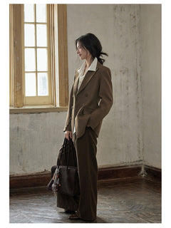 Side profile of brown blazer showing relaxed silhouette and buttoned cuffs.