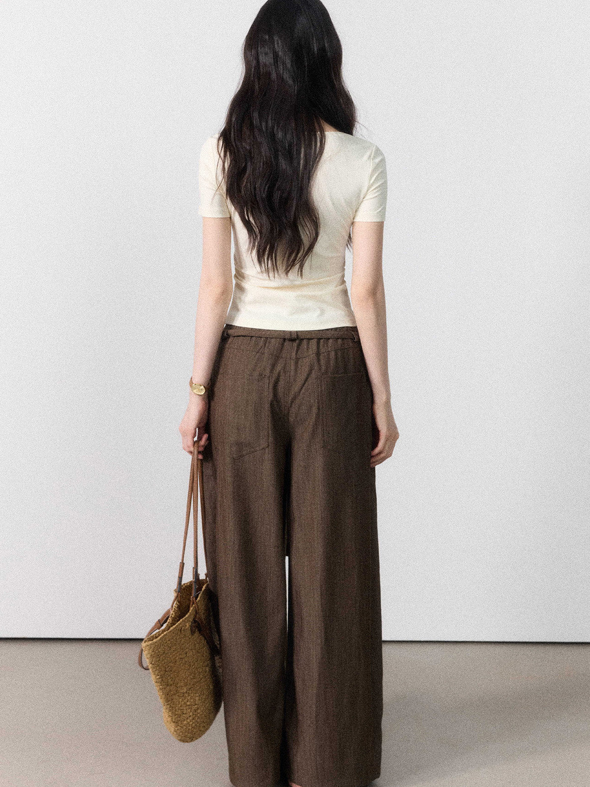 Brown wide-leg pants displayed flat, showing front pockets and tie belt