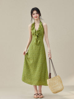 Halter neck dress with ruffled detail and small green floral print.