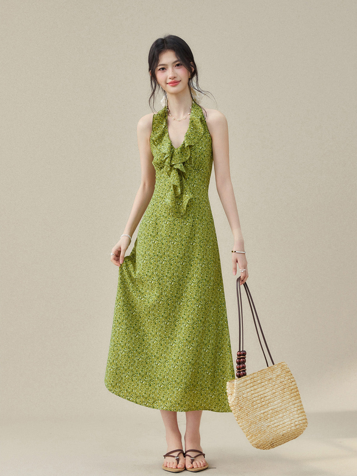 Halter neck dress with ruffled detail and small green floral print.