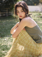 Yellow plaid a-line skirt shown from back with bow detail