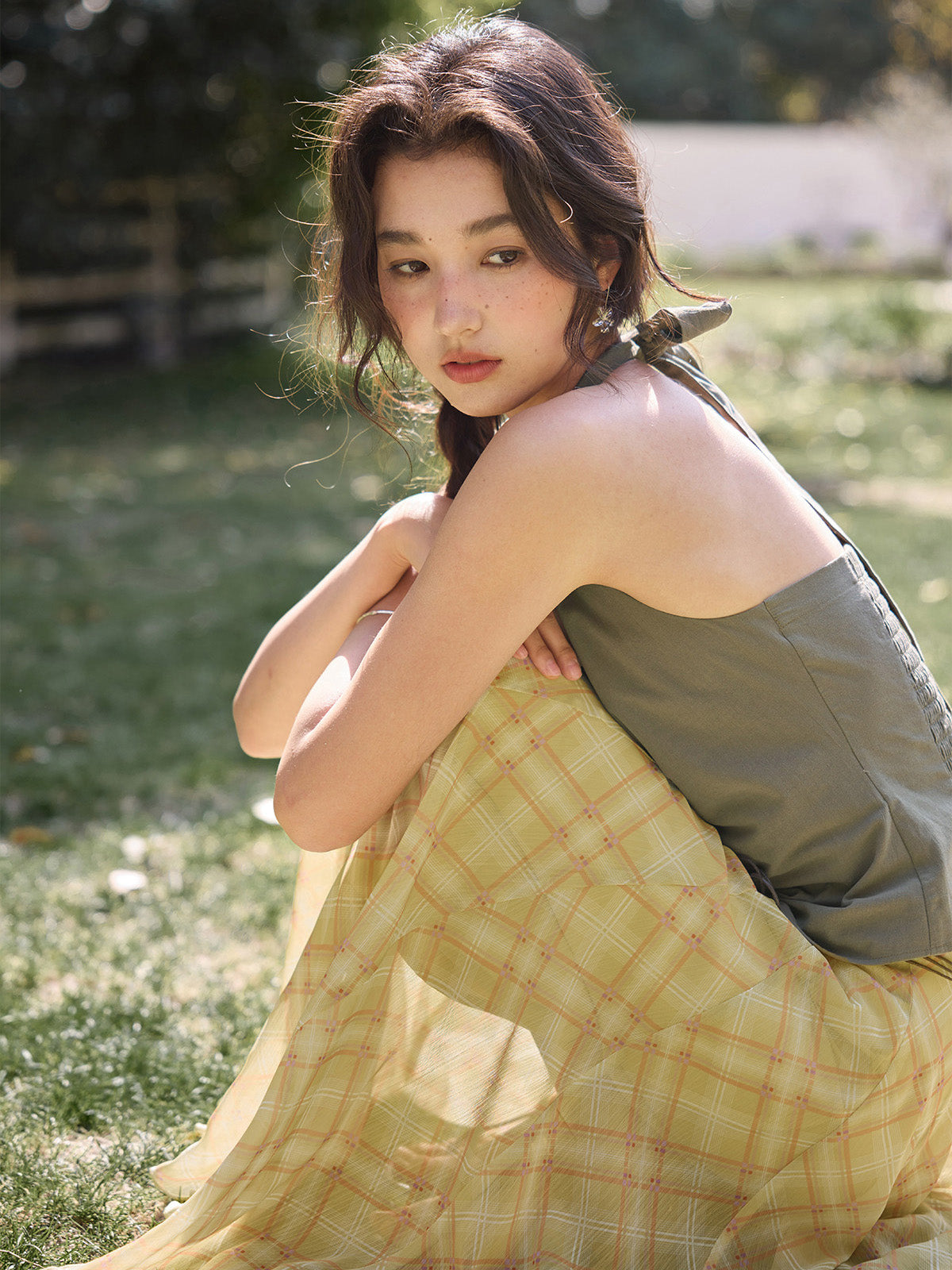 Yellow plaid a-line skirt shown from back with bow detail