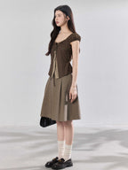 Side view of a model wearing the brown puff sleeve top.