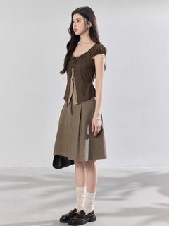 Side view of a model wearing the brown puff sleeve top.
