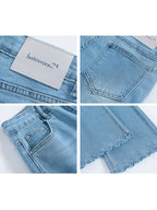 Front view of high rise light blue flared jeans with embroidered stars on hem.