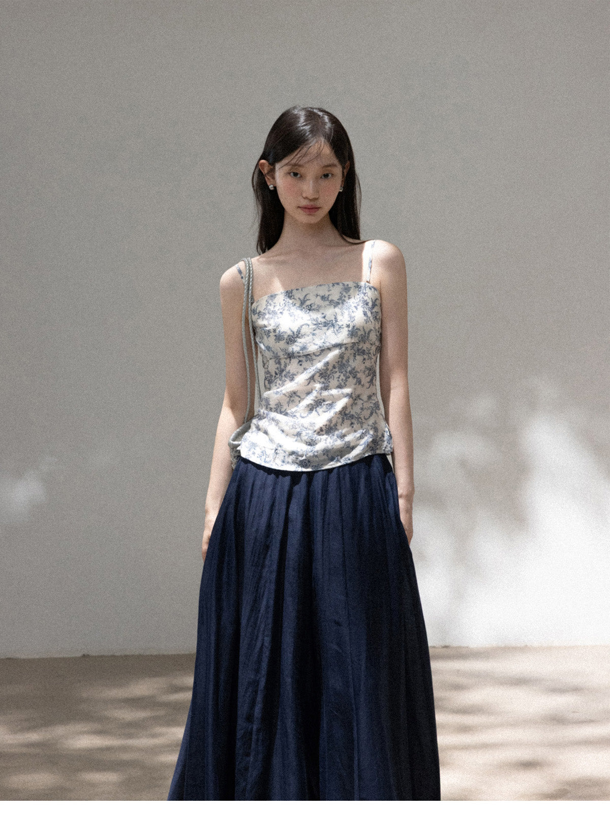 Model wearing blue floral fitted camisole with square neckline