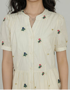 Side pockets visible on an A-line dress with floral embroidery.