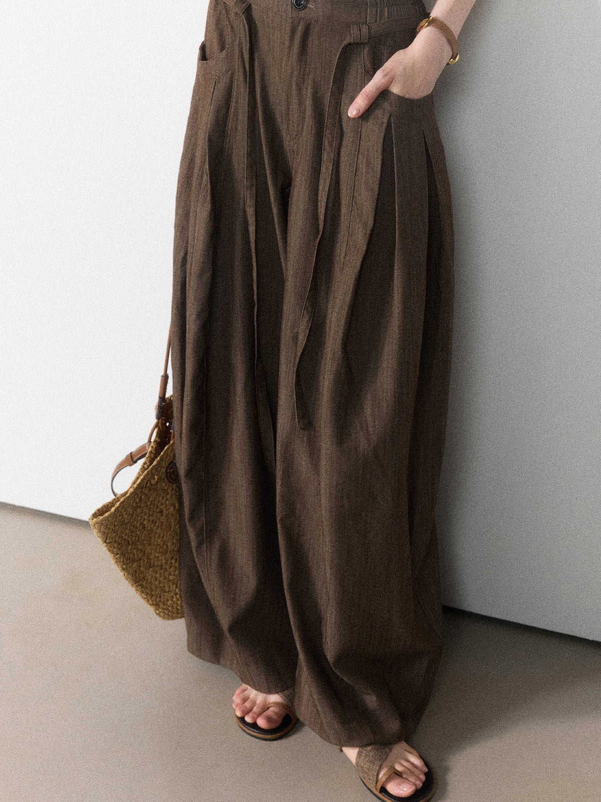 Brown wide-leg pants with a tie belt and front pockets