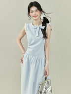 Light blue dress with vertical stripes, lace trim on the shoulders and hem, a bow tie neckline, gathered waist, A-line silhouette, and lace trim.