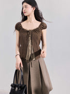 Close-up of the ruched bust and square neckline on a brown puff sleeve top.