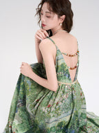 Front view of green floral dress featuring a bow at the waist.