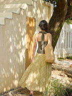 Yellow plaid long skirt hanging on metal rack outdoors