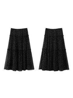 Front view of black floral skirt featuring small white print on sheer overlay