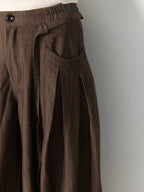Brown wide-leg pants with an elastic waistband and button closure