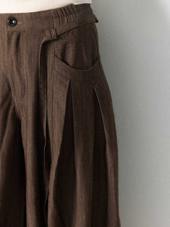 Brown wide-leg pants with an elastic waistband and button closure